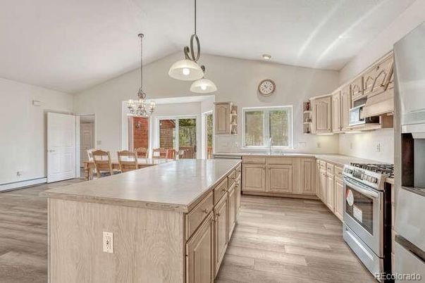 Chandelier, Dining room, Interior, Kitchen, Pendant Lights, Recessed Lighting, Stainless Steel Appliances, Wood Texture Flooring