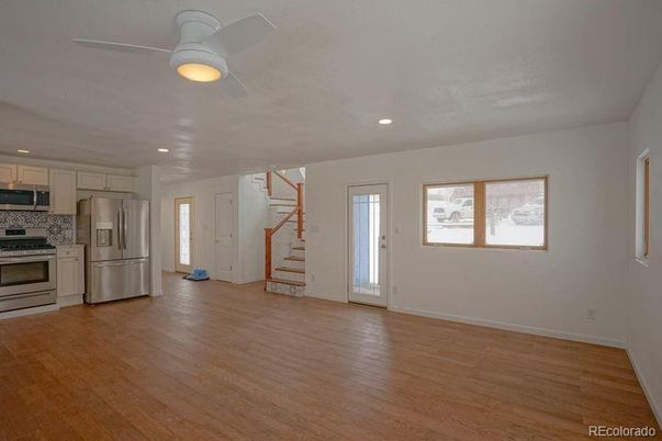 Empty room, Interior, Kitchen, Recessed Lighting, Stainless Steel Appliances, Wood Texture Flooring