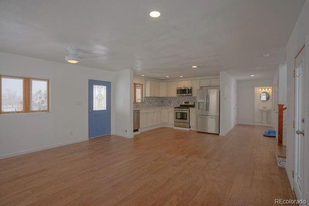 Empty room, Interior, Kitchen, Recessed Lighting, Stainless Steel Appliances, Wood Texture Flooring
