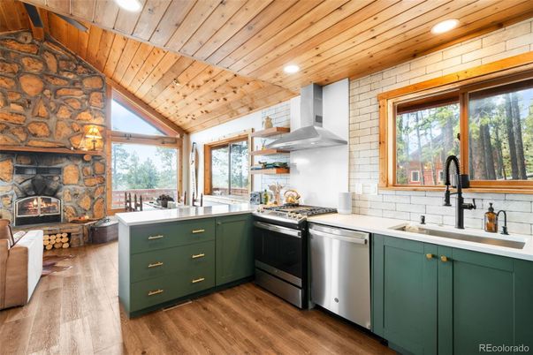 Fireplace, Interior, Kitchen, Recessed Lighting, Stainless Steel Appliances, Stone Walls, Wooden Ceilings, Wood Texture Flooring