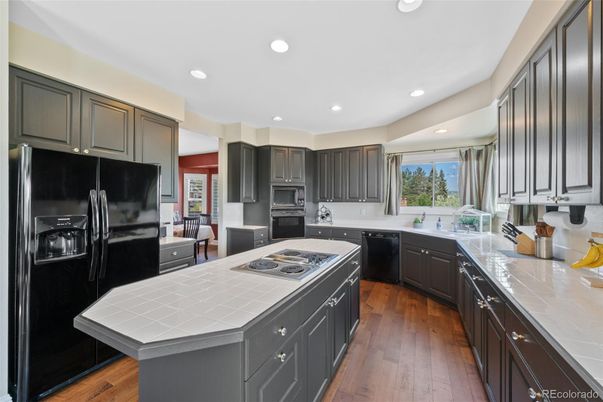 Interior, Kitchen, Recessed Lighting, Tile Countertops, Wood Texture Flooring
