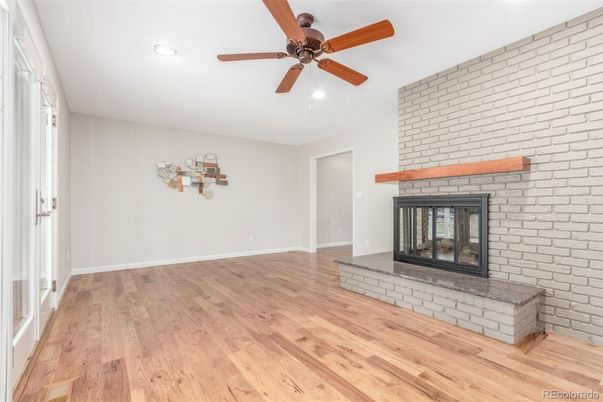 Empty room, Fireplace, Interior, Recessed Lighting, Stone Walls, Wood Texture Flooring