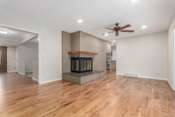 Empty room, Fireplace, Interior, Recessed Lighting, Stone Walls, Wood Texture Flooring