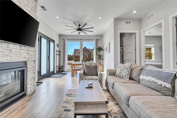 Fireplace, Interior, Living room, Recessed Lighting, Stone Walls, Wood Texture Flooring