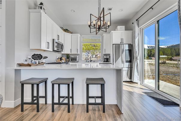 Chandelier, Interior, Kitchen, Pendant Lights, Recessed Lighting, Stainless Steel Appliances, Wood Texture Flooring