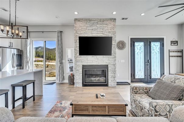 Fireplace, Interior, Living room, Pendant Lights, Recessed Lighting, Stone Walls, Wood Texture Flooring