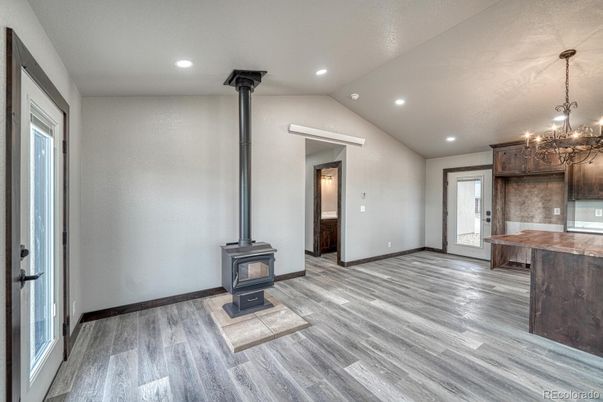 Chandelier, Empty room, Fireplace, Interior, Recessed Lighting, Wood Texture Flooring