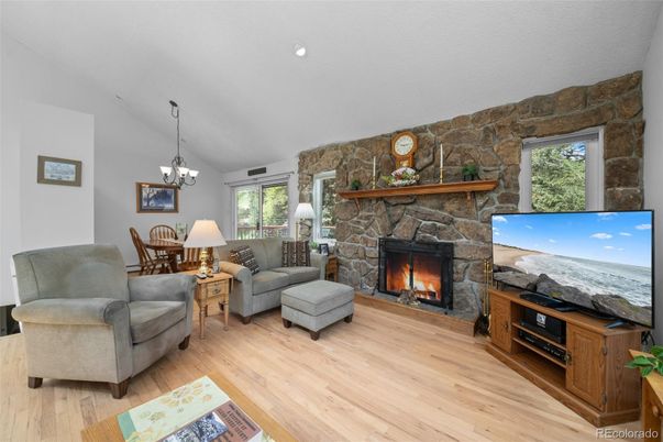 Chandelier, Dining room, Fireplace, Interior, Pendant Lights, Recessed Lighting, Stone Walls, Wood Texture Flooring
