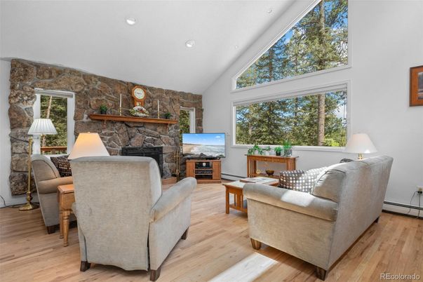 Fireplace, Interior, Living room, Recessed Lighting, Stone Walls, Wood Texture Flooring