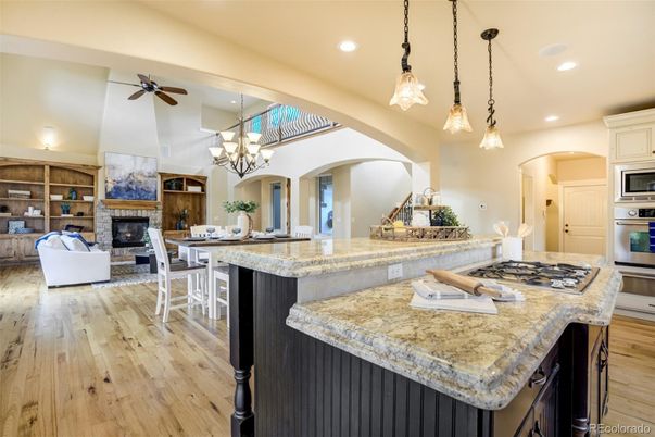 Chandelier, Dining room, Fireplace, Interior, Kitchen, Living room, Pendant Lights, Recessed Lighting, Stainless Steel Appliances, Wood Texture Flooring
