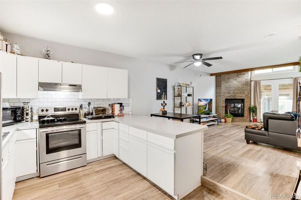 Fireplace, Interior, Kitchen, Living room, Recessed Lighting, Stainless Steel Appliances, Stone Walls, Wood Texture Flooring