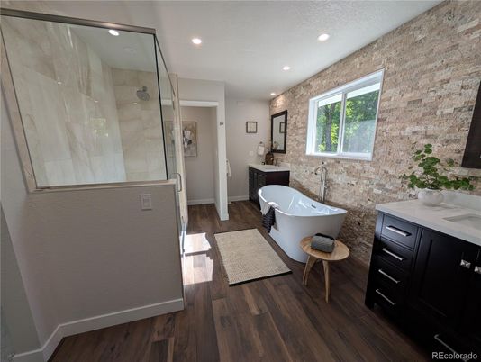 Bathroom, Free Standing Baths, Glass Shower, Interior, Recessed Lighting, Stone Walls, Wood Texture Flooring