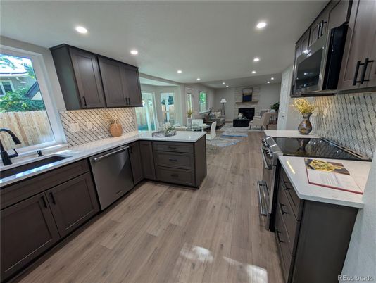 Dining room, Fireplace, Interior, Kitchen, Living room, Recessed Lighting, Stainless Steel Appliances, Wood Texture Flooring