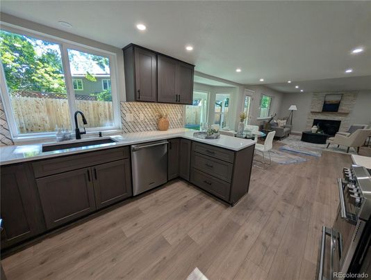 Dining room, Fireplace, Interior, Kitchen, Living room, Recessed Lighting, Stainless Steel Appliances, Stone Walls, Wood Texture Flooring