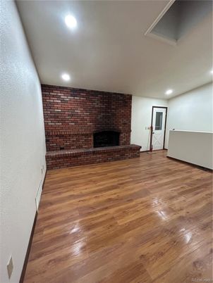 Empty room, Fireplace, Interior, Recessed Lighting, Stone Walls, Wood Texture Flooring