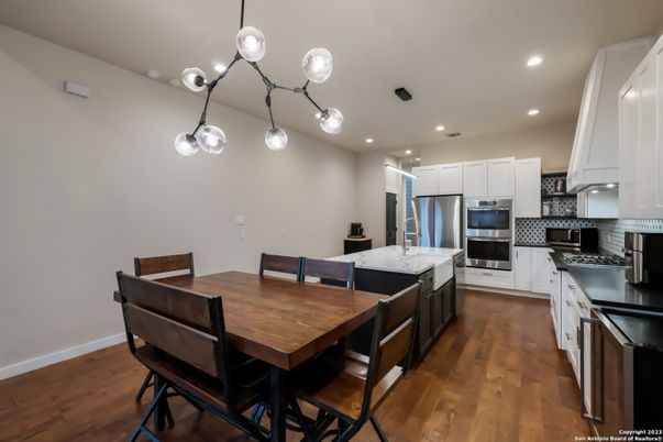 Dining room, Interior, Kitchen, Pendant Lights, Recessed Lighting, Stainless Steel Appliances, Wood Texture Flooring