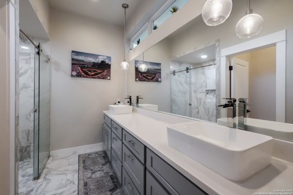 Bathroom, Dual Sink Vanities, Free Standing Baths, Glass Shower, Interior, Marble, Marble Walls, Pendant Lights, Recessed Lighting
