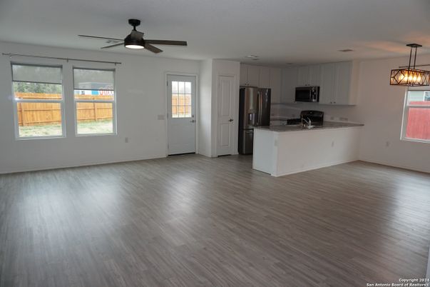 Empty room, Interior, Kitchen, Pendant Lights, Stainless Steel Appliances, Wood Texture Flooring