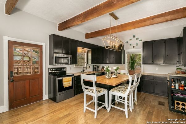 Chandelier, Dining room, Interior, Kitchen, Pendant Lights, Stainless Steel Appliances, Wooden Beams, Wood Texture Flooring