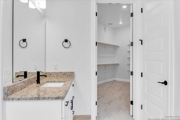 Bathroom, Dual Sink Vanities, Interior, Marble, Recessed Lighting, Walk-in Closets