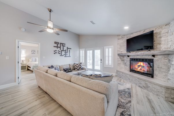 Fireplace, Interior, Living room, Recessed Lighting, Stone Walls, Wood Texture Flooring