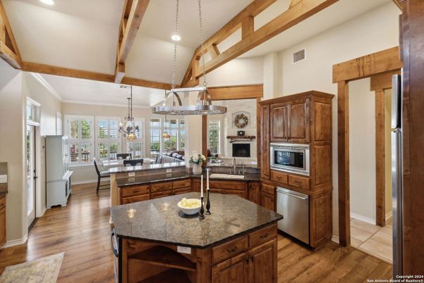 Chandelier, Dining room, Interior, Kitchen, Pendant Lights, Recessed Lighting, Stainless Steel Appliances, Wooden Beams, Wood Texture Flooring