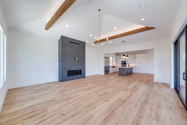 Empty room, Fireplace, Interior, Kitchen, Pendant Lights, Recessed Lighting, Wooden Beams, Wood Texture Flooring