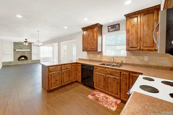 Chandelier, Fireplace, Interior, Kitchen, Pendant Lights, Recessed Lighting, Stone Walls, Wood Texture Flooring