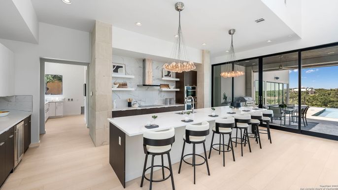 Chandelier, Interior, Kitchen, Marble Walls, Pendant Lights, Recessed Lighting, Stainless Steel Appliances, Wood Texture Flooring