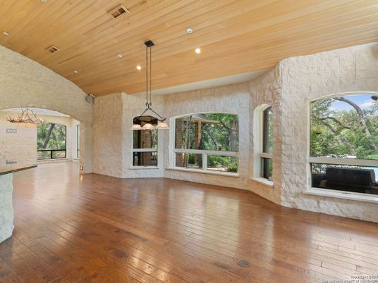 Empty room, Fireplace, Interior, Pendant Lights, Recessed Lighting, Stone Walls, Wooden Ceilings, Wood Texture Flooring