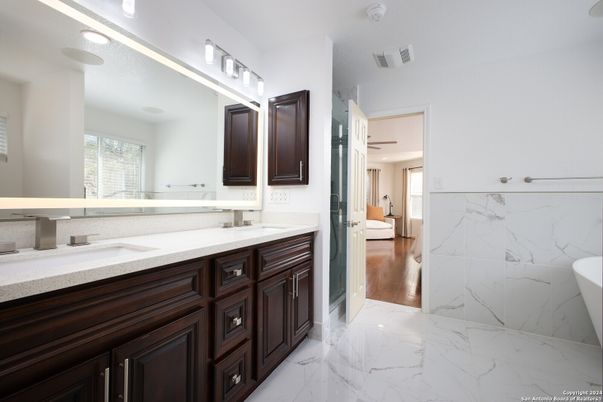 Bathroom, Dual Sink Vanities, Interior, Marble, Marble Walls, Recessed Lighting, Wood Texture Flooring