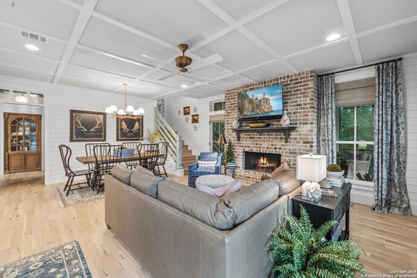 Dining room, Fireplace, Interior, Living room, Recessed Lighting, Stone Walls, Wood Texture Flooring