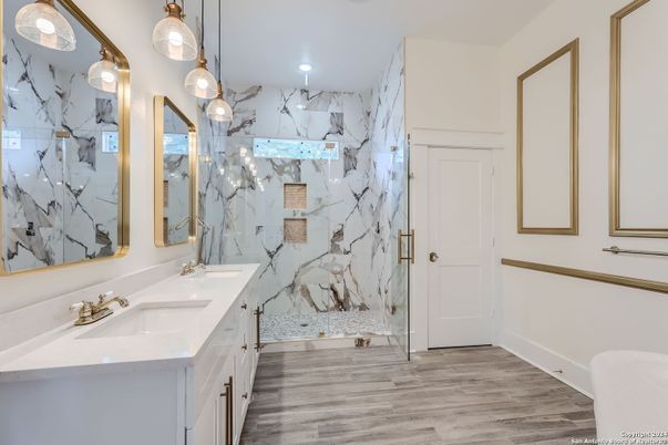 Bathroom, Dual Sink Vanities, Glass Shower, Interior, Marble Walls, Pendant Lights, Recessed Lighting, Wood Texture Flooring