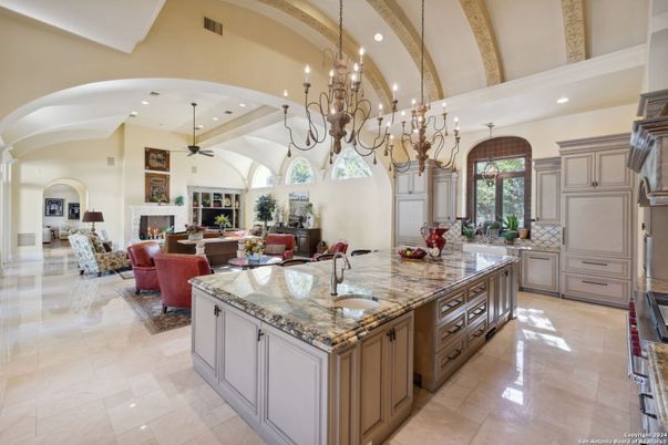 Chandelier, Fireplace, Interior, Kitchen, Living room, Pendant Lights, Recessed Lighting, Stainless Steel Appliances, Wooden Beams