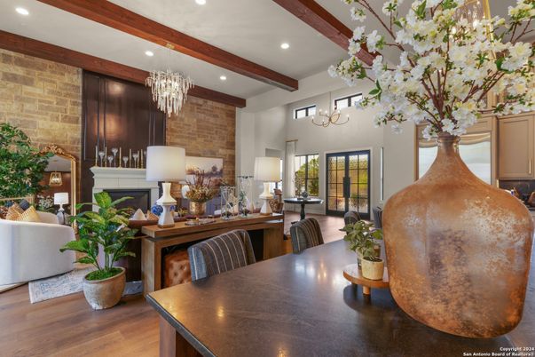 Chandelier, Dining room, Fireplace, Interior, Recessed Lighting, Stone Walls, Wooden Beams, Wood Texture Flooring