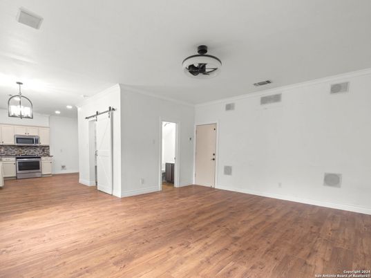 Empty room, Interior, Kitchen, Pendant Lights, Recessed Lighting, Stainless Steel Appliances, Wood Texture Flooring