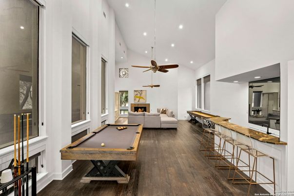 Billiard Table, Fireplace, Game Room, Interior, Living room, Pendant Lights, Recessed Lighting, Wood Texture Flooring