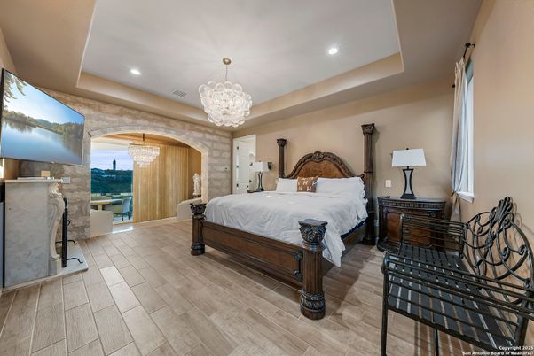 Bedroom, Chandelier, Fireplace, Interior, Recessed Lighting, Wood Texture Flooring
