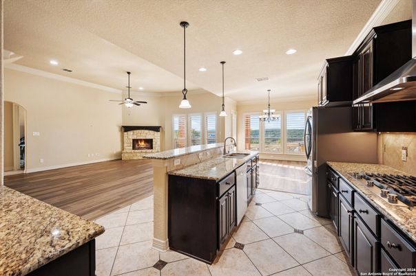 Chandelier, Fireplace, Interior, Kitchen, Pendant Lights, Recessed Lighting, Wood Texture Flooring