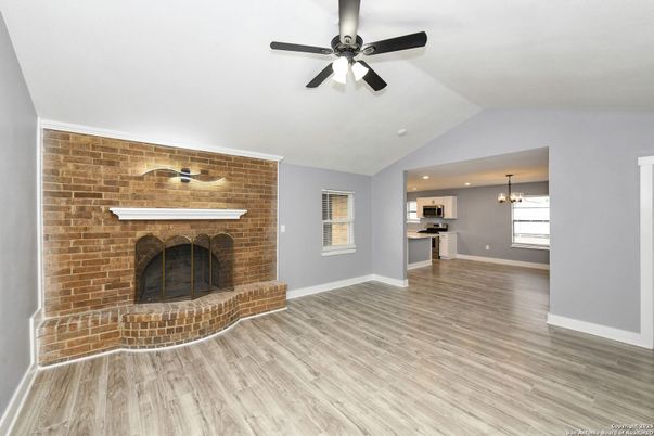 Empty room, Fireplace, Interior, Kitchen, Pendant Lights, Recessed Lighting, Stone Walls, Wood Texture Flooring