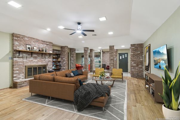 Fireplace, Interior, Living room, Recessed Lighting, Stone Walls, Wood Texture Flooring