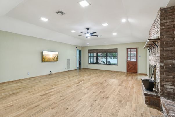 Empty room, Fireplace, Interior, Recessed Lighting, Stone Walls, Wood Texture Flooring