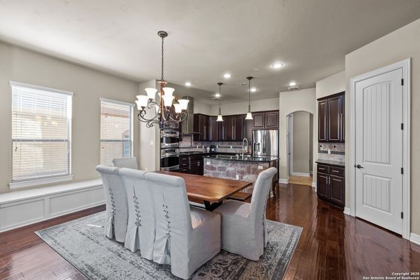 Chandelier, Dining room, Interior, Kitchen, Pendant Lights, Recessed Lighting, Stainless Steel Appliances, Wood Texture Flooring