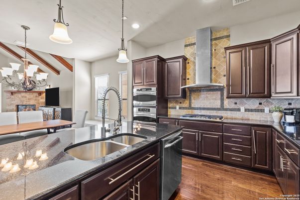 Fireplace, Interior, Kitchen, Pendant Lights, Recessed Lighting, Stainless Steel Appliances, Wood Texture Flooring