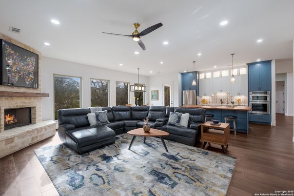 Fireplace, Interior, Kitchen, Living room, Pendant Lights, Recessed Lighting, Stainless Steel Appliances, Wood Texture Flooring