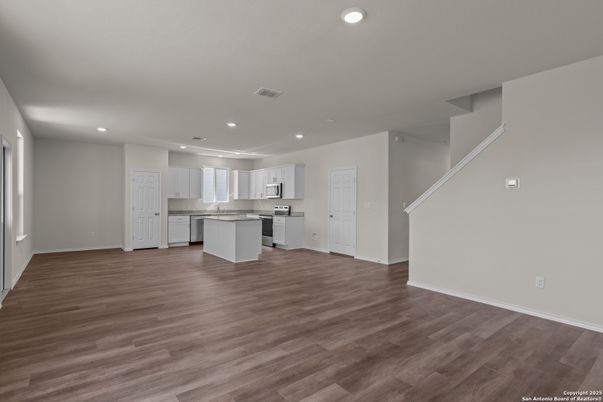 Empty room, Interior, Kitchen, Recessed Lighting, Stainless Steel Appliances, Wood Texture Flooring