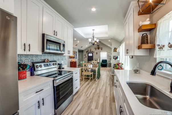 Chandelier, Dining room, Interior, Kitchen, Recessed Lighting, Stainless Steel Appliances, Wood Texture Flooring
