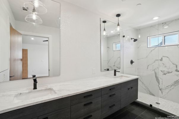 Bathroom, Dual Sink Vanities, Glass Shower, Interior, Marble Walls, Pendant Lights, Recessed Lighting