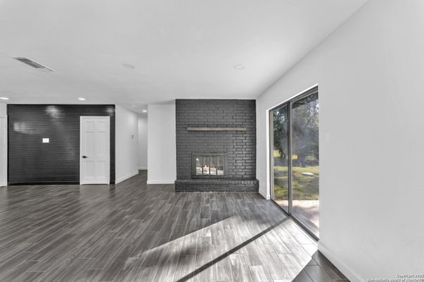 Empty room, Fireplace, Interior, Recessed Lighting, Stone Walls, Wood Texture Flooring