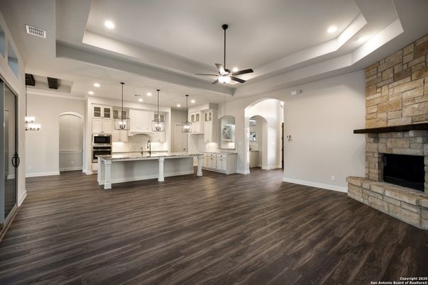 Fireplace, Interior, Kitchen, Pendant Lights, Recessed Lighting, Stainless Steel Appliances, Stone Walls, Wood Texture Flooring